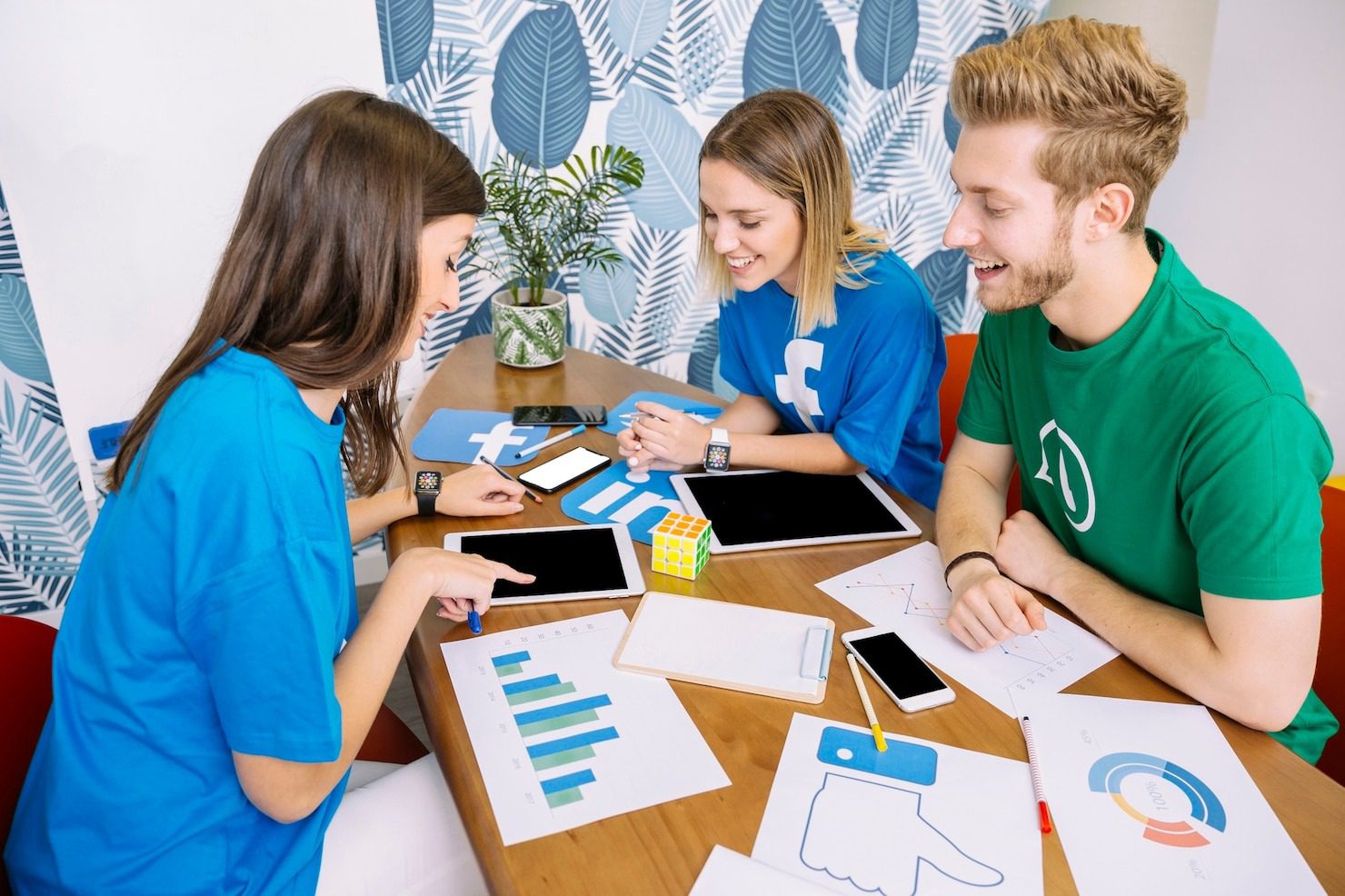 Social media agency team in NJ & NYC smiling while viewing content on a tablet